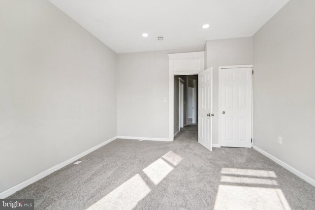 unfurnished bedroom with light colored carpet