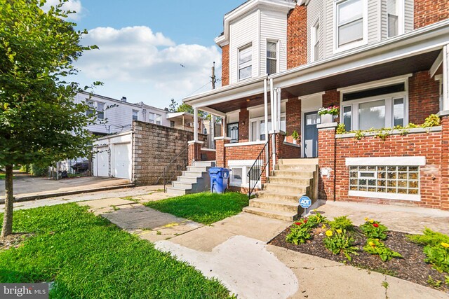 view of property featuring a garage and a porch