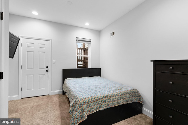 bedroom with light colored carpet