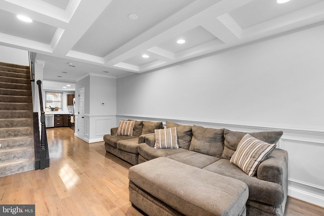 living room featuring coffered ceiling, beamed ceiling, and light hardwood / wood-style flooring