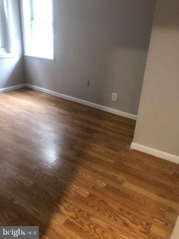 unfurnished room featuring dark hardwood / wood-style floors