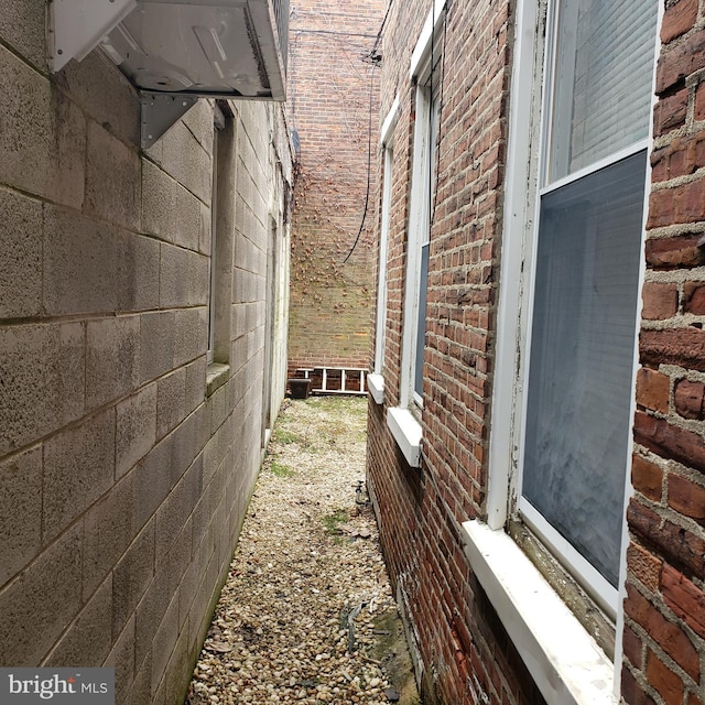 view of home's exterior featuring entry steps and brick siding