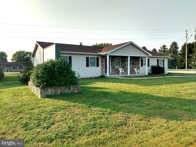 single story home featuring stone siding, covered porch, and a front yard