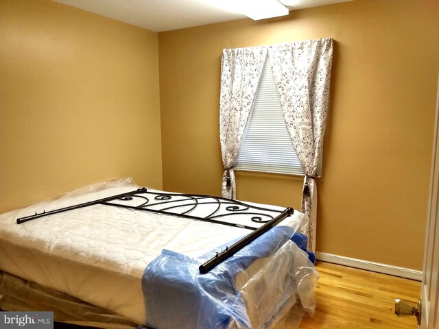 bedroom with wood-type flooring