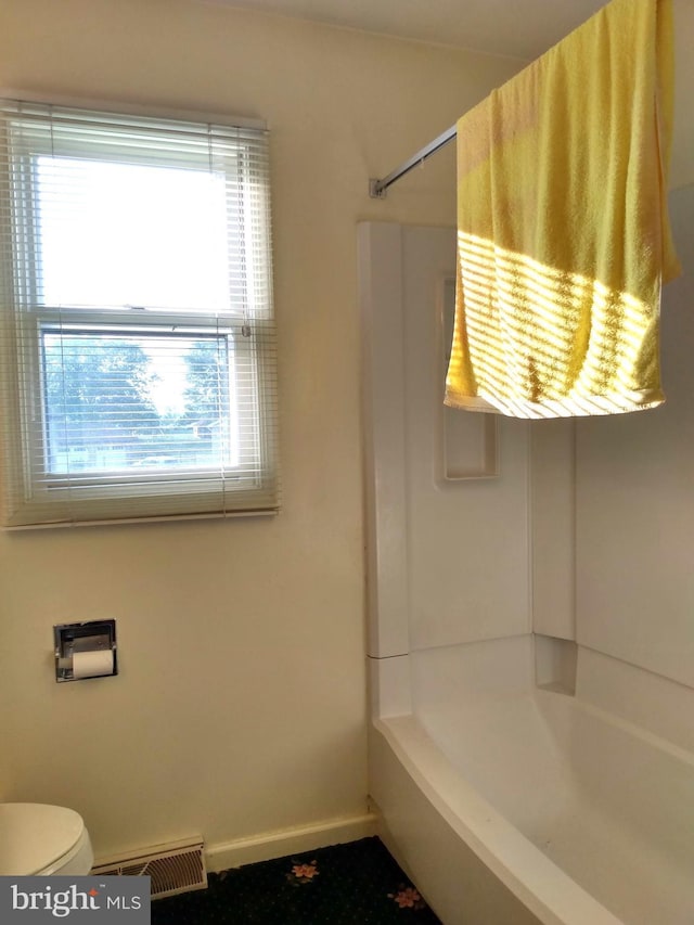 bathroom with baseboards, visible vents, and toilet