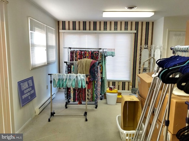 workout room featuring a baseboard radiator, baseboards, and carpet flooring