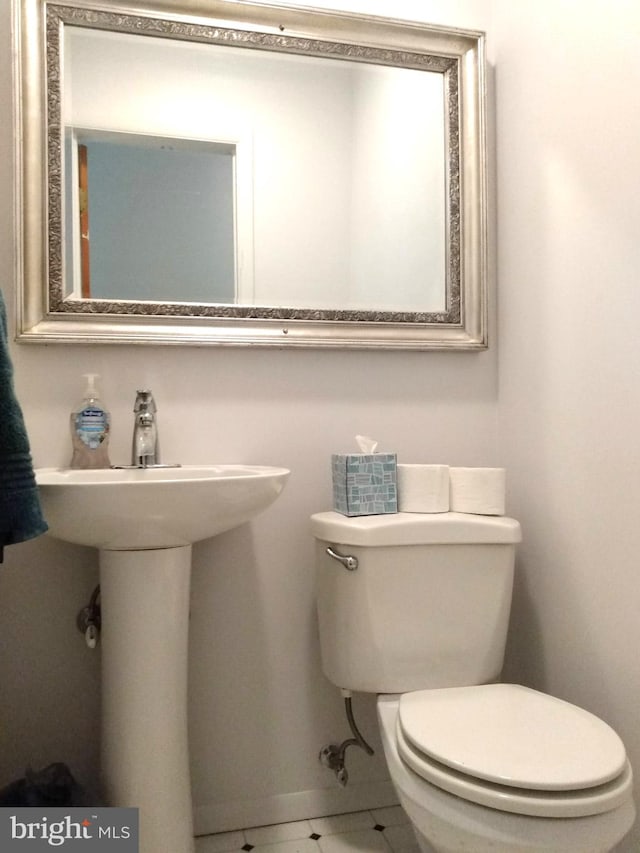 bathroom featuring tile patterned flooring and toilet