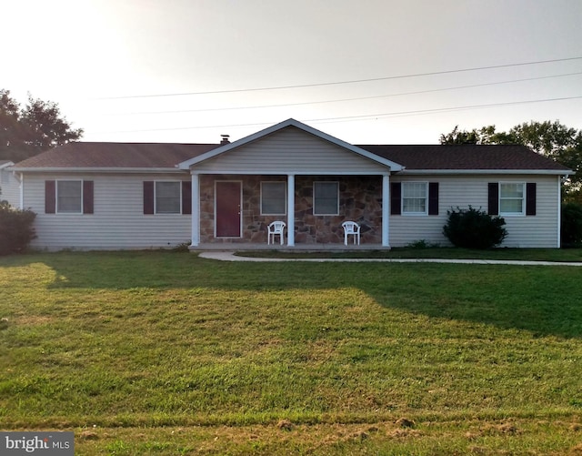 ranch-style house with stone siding and a front yard