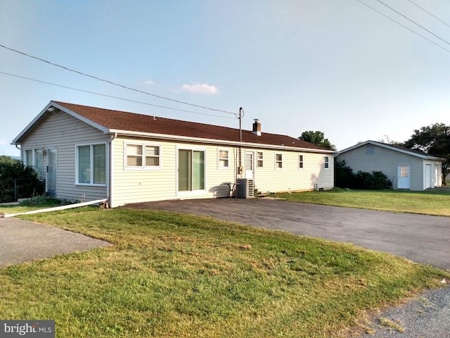 view of front of house with a front lawn and cooling unit