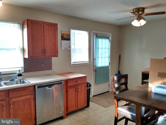 kitchen featuring stainless steel dishwasher, ceiling fan, sink, and light carpet