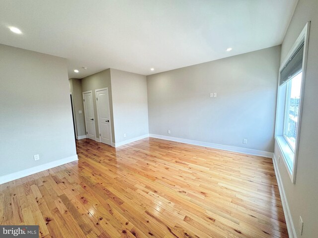 unfurnished room with light wood-type flooring