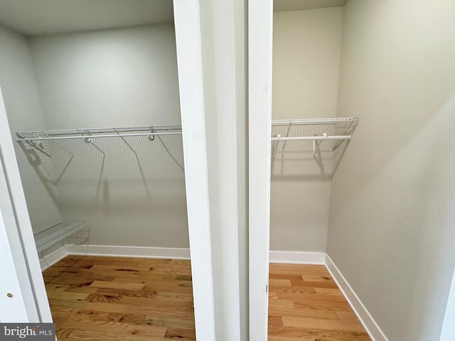 spacious closet with wood finished floors