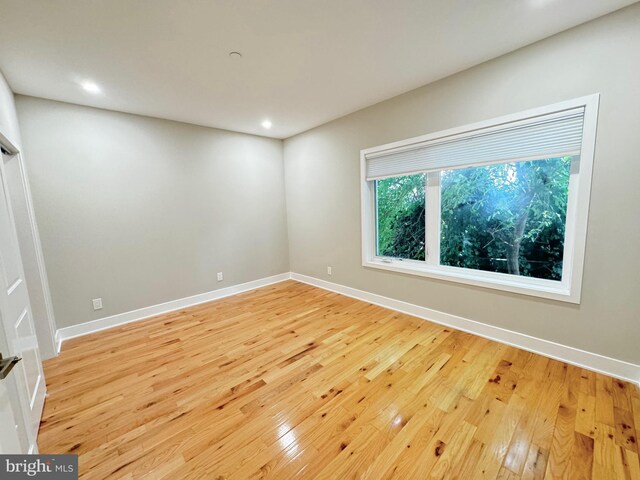 empty room with light hardwood / wood-style floors