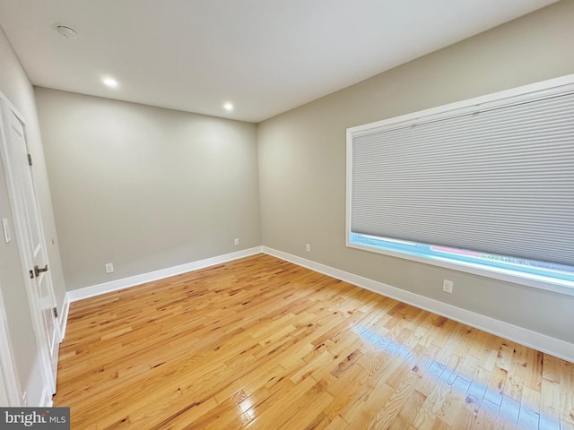 unfurnished room featuring light wood-style floors, baseboards, and recessed lighting