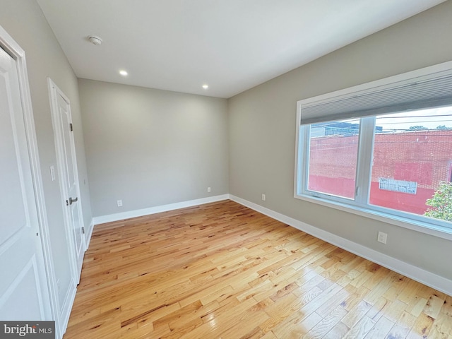 spare room featuring light wood-type flooring