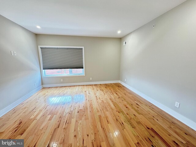 unfurnished room with light wood-type flooring