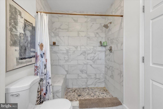 bathroom featuring toilet and curtained shower