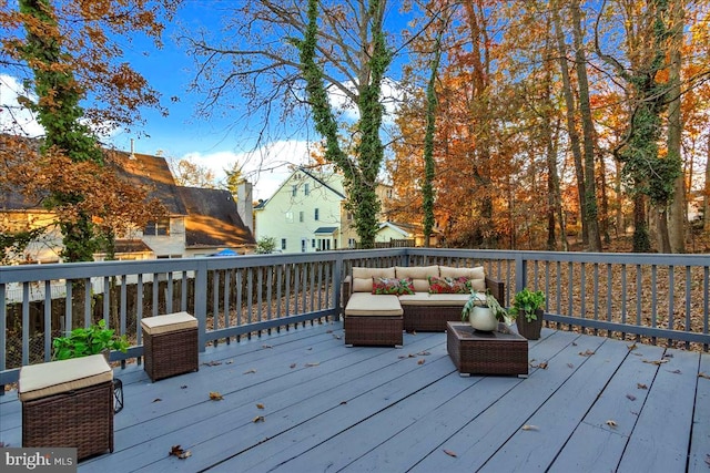 wooden deck with an outdoor living space