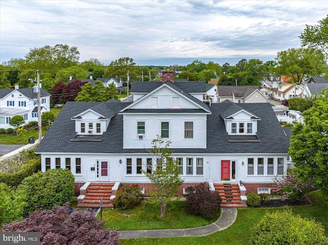 view of front of home featuring a shingled roof and a residential view