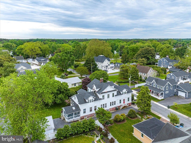 birds eye view of property with a residential view and a forest view