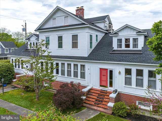 view of front of property with entry steps, roof with shingles, and board and batten siding