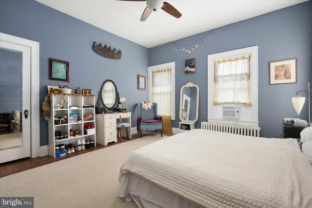 bedroom featuring baseboards, ceiling fan, dark wood finished floors, and radiator