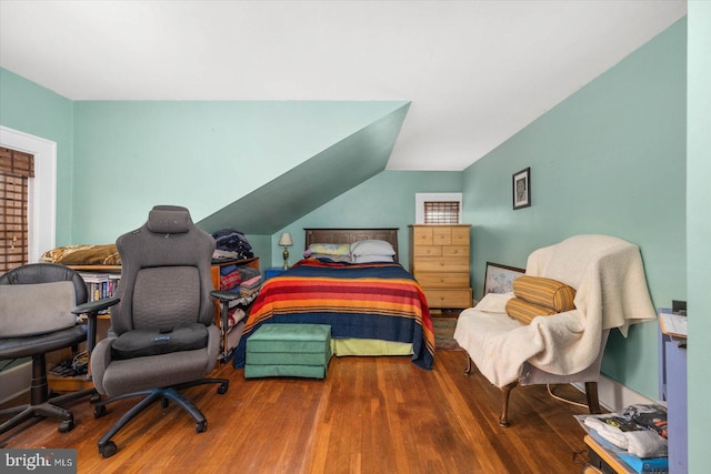 bedroom featuring vaulted ceiling and wood finished floors