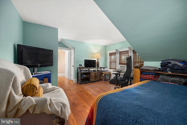 bedroom featuring vaulted ceiling and wood finished floors