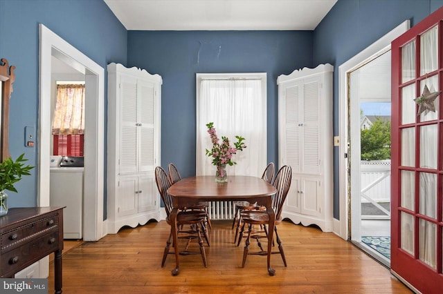 dining area featuring washer / dryer and light wood-style floors