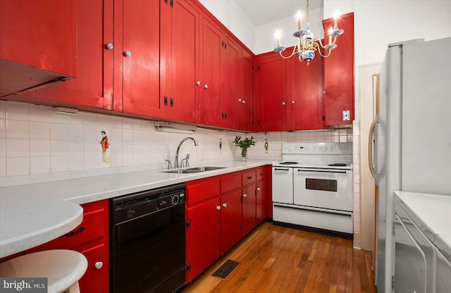 kitchen with electric range, dishwasher, freestanding refrigerator, light countertops, and a sink