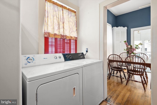 laundry area featuring separate washer and dryer and wood finished floors