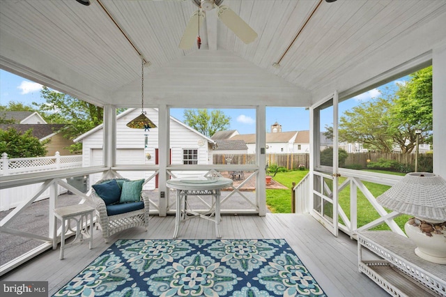 sunroom with a ceiling fan and lofted ceiling