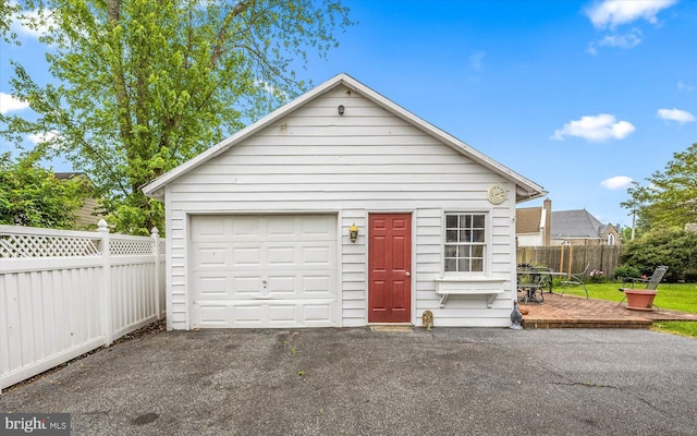 detached garage featuring fence