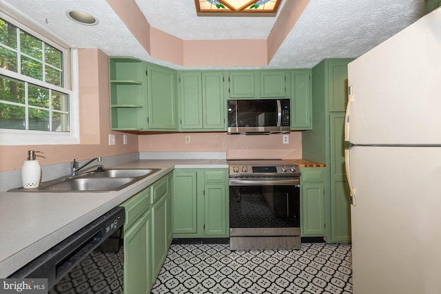 kitchen featuring sink, a textured ceiling, light tile patterned floors, and stainless steel appliances