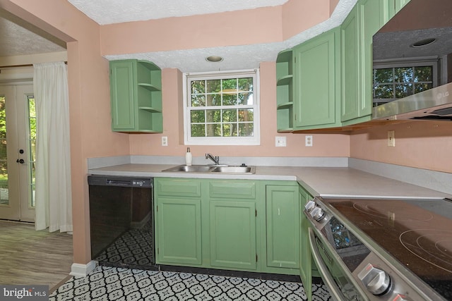 kitchen with hardwood / wood-style flooring, stainless steel appliances, sink, and green cabinetry