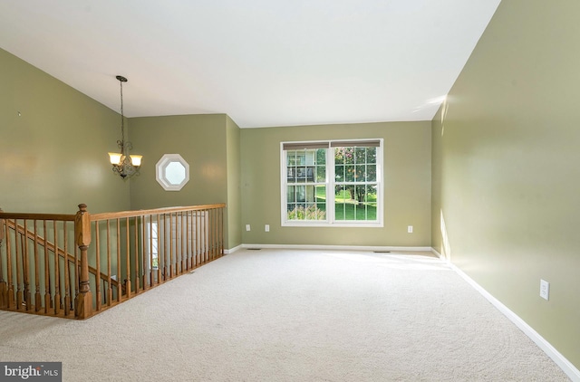 unfurnished room with carpet flooring and an inviting chandelier