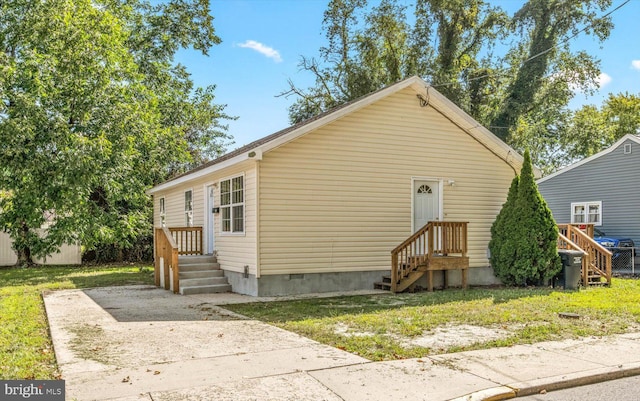 exterior space with crawl space and a front yard