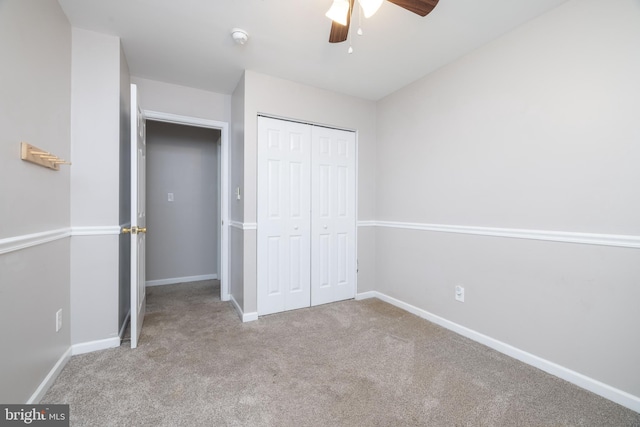 unfurnished bedroom with light carpet, ceiling fan, and a closet