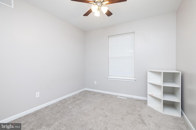 carpeted empty room featuring ceiling fan