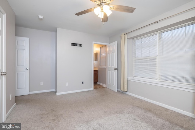 unfurnished bedroom featuring light carpet and ceiling fan