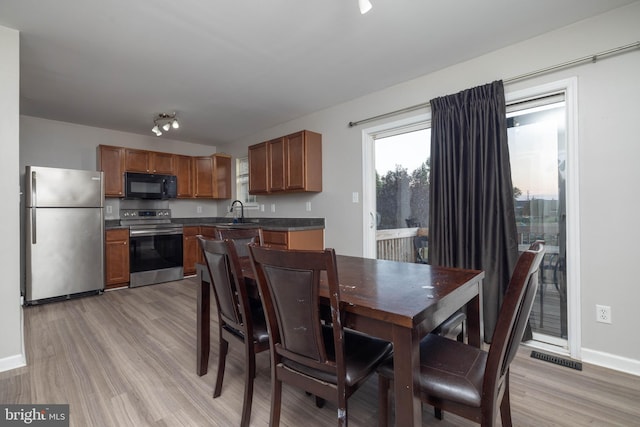 dining area featuring light hardwood / wood-style flooring and sink