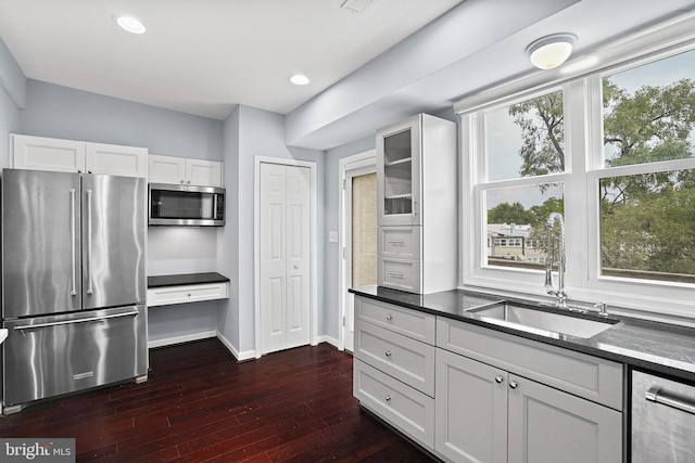 kitchen featuring dark wood-type flooring, white cabinets, appliances with stainless steel finishes, and sink