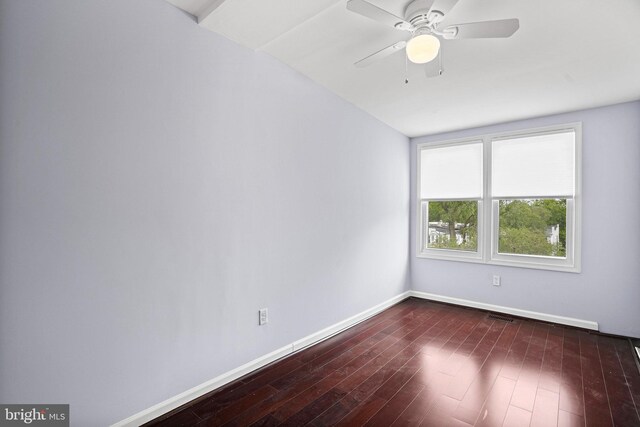 spare room featuring dark wood-type flooring, ceiling fan, and lofted ceiling