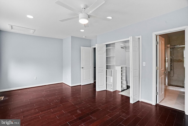 unfurnished bedroom featuring dark hardwood / wood-style flooring, ensuite bath, a closet, and ceiling fan