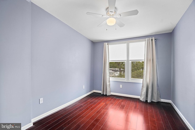 unfurnished room with ceiling fan and dark hardwood / wood-style flooring