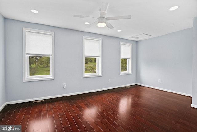 empty room featuring ceiling fan and dark hardwood / wood-style flooring