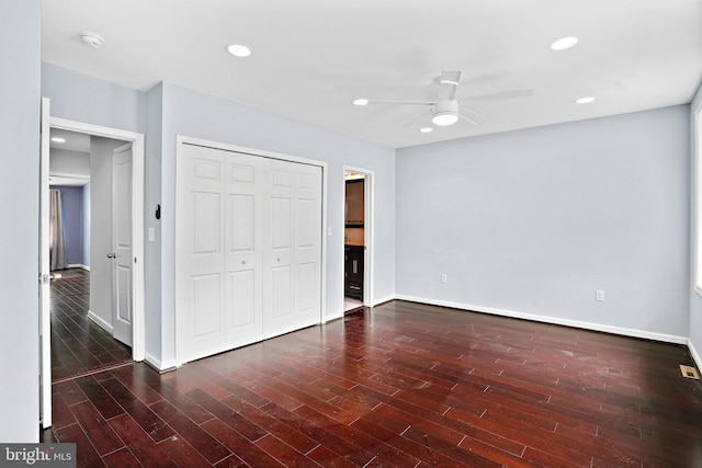 unfurnished bedroom with a closet, ceiling fan, and dark hardwood / wood-style flooring