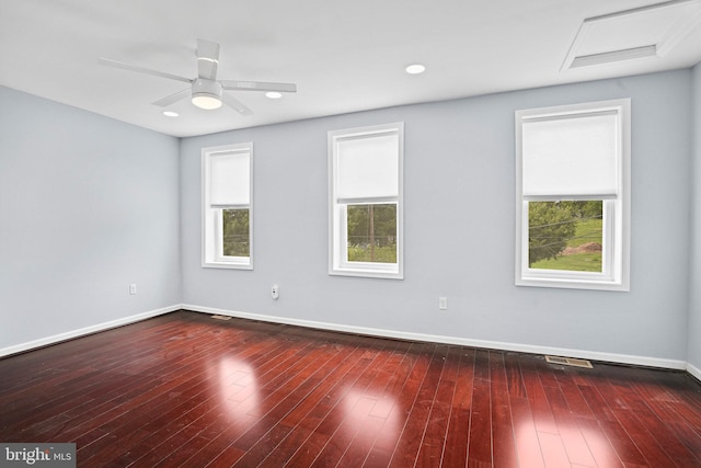 unfurnished room with a wealth of natural light, ceiling fan, and dark hardwood / wood-style flooring