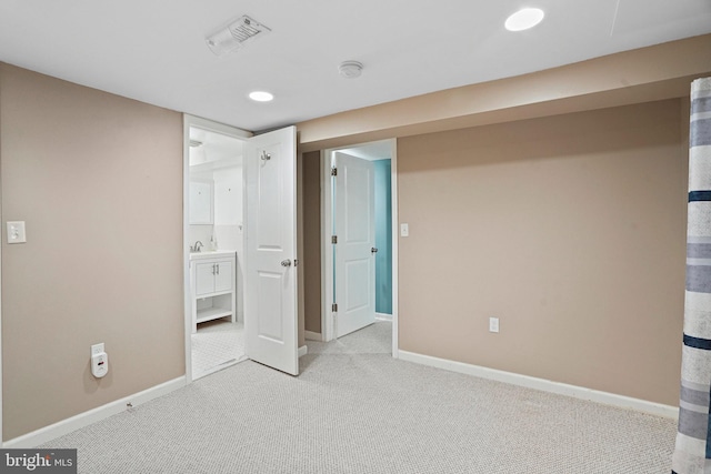 interior space with ensuite bath and carpet flooring