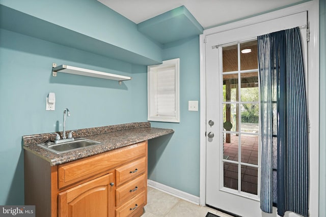 kitchen with sink and light tile patterned flooring